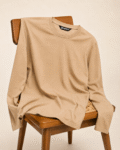 Premium beige full sleeve cotton t-shirt for men placed on wooden chair with minimalist old money aesthetic styling by Benrren